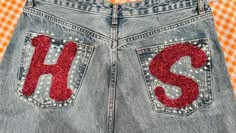 a pair of jeans with sequins and the letter s on them are shown