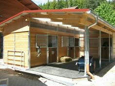 a horse barn with stalls and horses inside