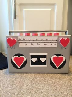 a toy radio with hearts on it sitting on a counter next to a white door