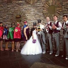 a group of people standing next to each other in front of a stone wall and wearing costumes