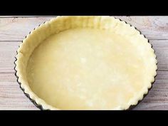 an uncooked pie crust sitting on top of a wooden table