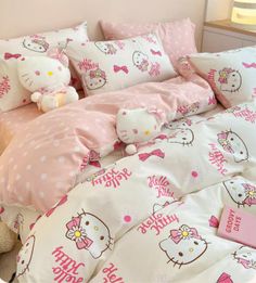 a bed with hello kitty sheets and pillows