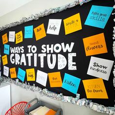 a bulletin board that says ways to show gratitue with lots of post it notes on it