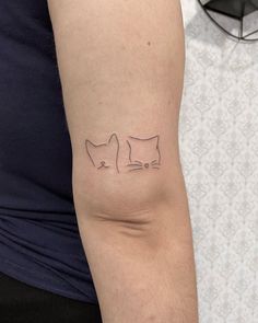 a person with a cat tattoo on their arm