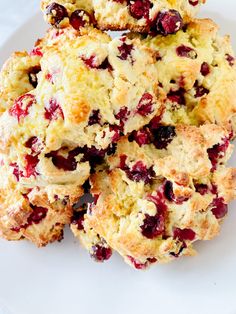 cranberry scones stacked on top of each other on a white plate,