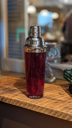 a shot glass sitting on top of a wooden counter