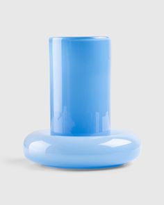 a blue vase sitting on top of a white table