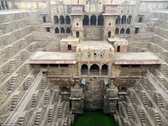 the inside of an old building with green water