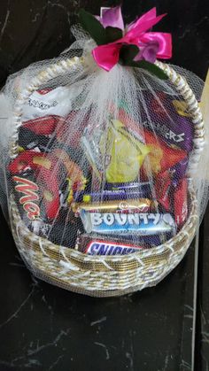 a basket filled with candy sitting on top of a table