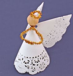 an ornament with gold beads on it sitting on top of a doily