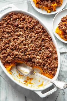 a casserole dish filled with ground beef and topped with a scoop of ice cream