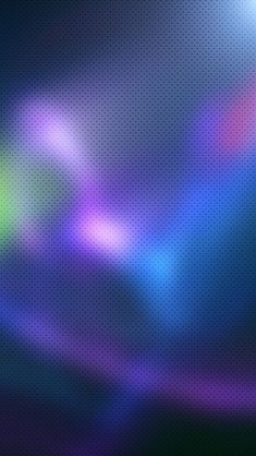 a blurry image of the colors of blue, purple and green on a black background