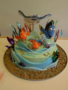 a birthday cake decorated to look like an ocean scene with fish and sea creatures on it