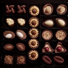 an assortment of chocolates in a black box