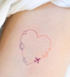 a small heart shaped tattoo with an airplane on it