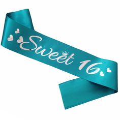 a blue ribbon with the words sweet 16 printed on it and hearts in white lettering