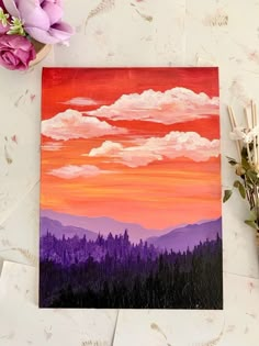 an acrylic painting of a sunset with mountains in the background and flowers nearby