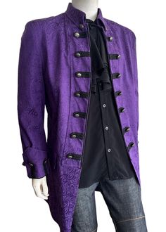 This 1775 British Army-inspired jacket is a classic Couture piece featuring distinctive contrast details reminiscent of the coats of the British Army. The modern design is expertly tailored in a purple brocade pattern and embellished with fleur de lis embossed metal buttons to give a timeless look. Elevate your outfit with this rockstar-style jacket.     Self: Cotton/Poly, Lining: Polyester     3/4 Length     Dry Clean Only     Made in USA Medieval Outfit, Rockstar Style, Joker Costume, Couture Jackets, Gothic Wedding, British Army, Mens Jackets, Jackets & Coats, Mens Outfits