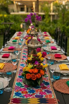 a long table is set with colorful place settings