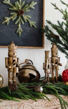 a mantle with christmas decorations and ornaments on it