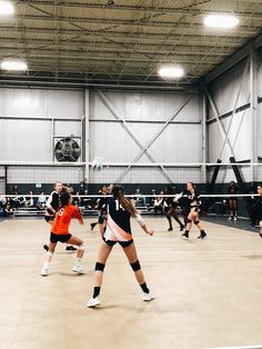 girls playing volleyball in an indoor gym