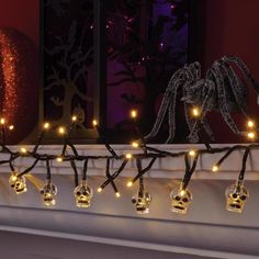 a mantle with skulls and lights on it