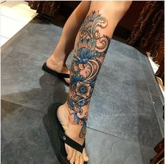 a woman's foot with blue flowers on it