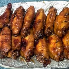 several pieces of chicken sitting on top of tin foil