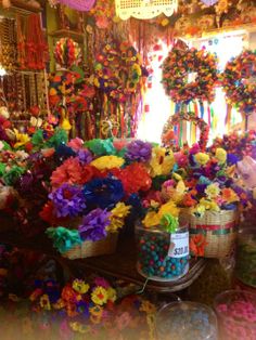 many baskets filled with lots of colorful flowers