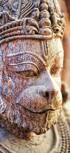 a close up of a stone statue with eyes closed