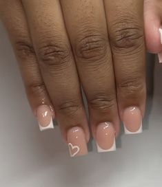 a woman's hands with french manies and hearts painted on their nails,