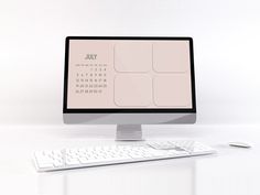 a desktop computer sitting on top of a white desk next to a keyboard and mouse