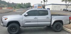 a silver truck parked in a parking lot