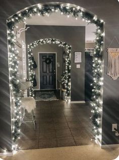 a hallway decorated for christmas with lights and decorations on the door, along with a chair