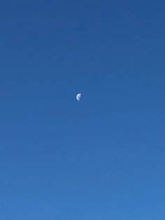 the moon is in the clear blue sky