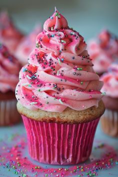 cupcakes with pink frosting and sprinkles