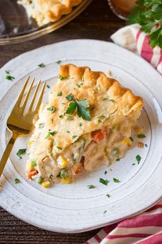 a slice of chicken pot pie on a plate with a fork