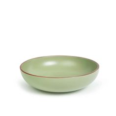 a green bowl sitting on top of a white table