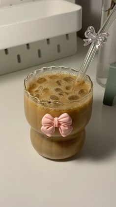 there is a drink with a pink bow in it