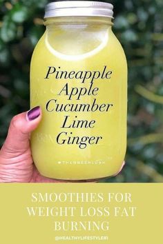 a woman holding up a jar of smoothie with the words pineapple apple cucumber lime ginger