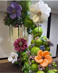 an arrangement of balloons and flowers on display