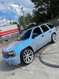 a silver suv parked in a parking lot