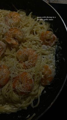 pasta with shrimp and parmesan cheese in a skillet