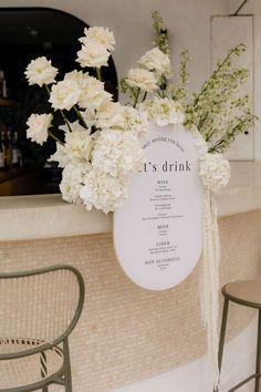 white flowers are sitting on top of a bar