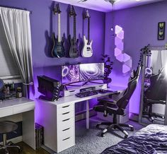 a bedroom with purple lighting and guitars hanging on the wall, along with a computer desk