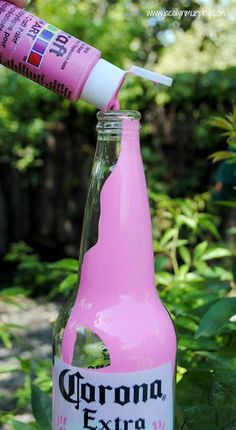 a close up of a pink bottle with a toothbrush in it