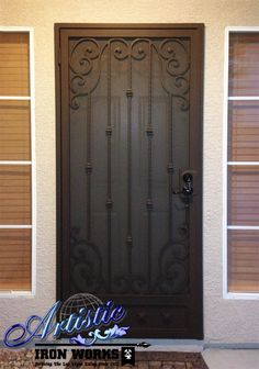 the front door to a home with brown shutters and an iron design on it