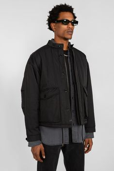 • Loose, boxy fitting workwear inspired jacket • Fully lined and quilted with a polyester filling • Drop shoulders with elbow pleats for added ease of movement and adjustable button sleeve cuffs• Hidden button and zipper front closure with stand collar• Two patch pockets with buttoned flaps at waist• Internal drawcord at hem • Vertical single needle topstitching across body and sleeves • Pictured with our Twisted Seam Pant in Washed Black Denim, Oversized Button Down Shirt in Washed Black and Sl Oversized Button Down Shirt, Sleeveless Knit Top, Work Jacket, Work Jackets, Stand Collar, Black Denim, Drop Shoulder, Front Zipper, Patch Pocket