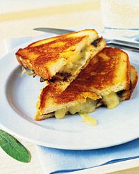 two grilled sandwiches sitting on top of a white plate