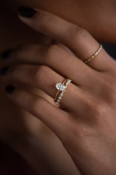 a woman's hand with a diamond ring on it